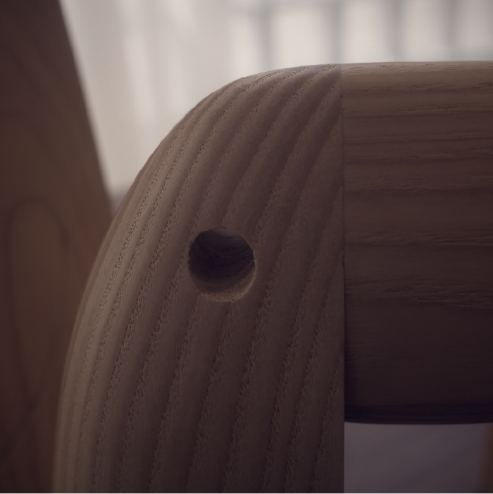 Close-up of a wooden chair with a blurred background