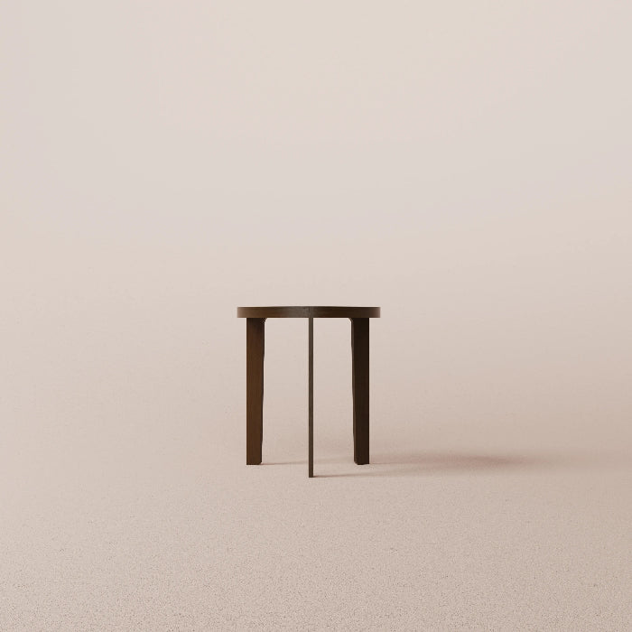 Small round wooden table on a beige background
