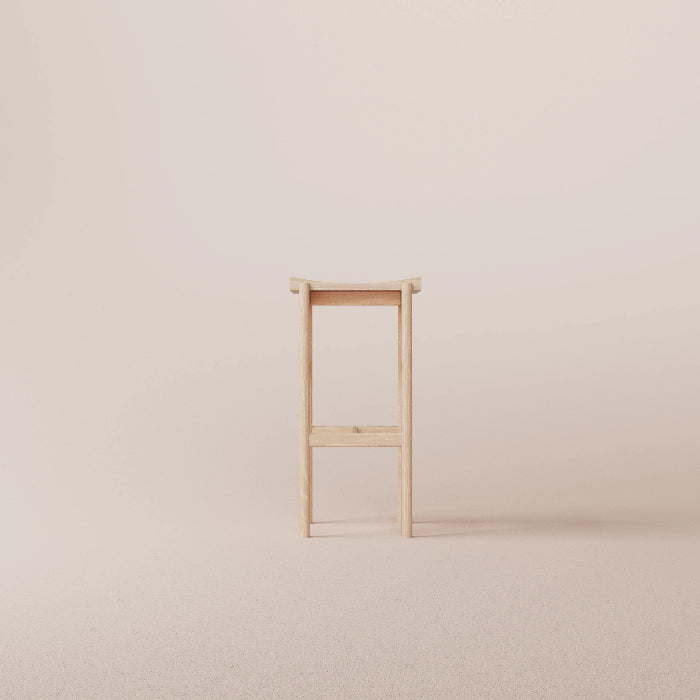 Wooden stool against a plain beige wall