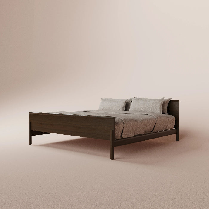 Bed with dark wooden frame and gray bedding on a beige background