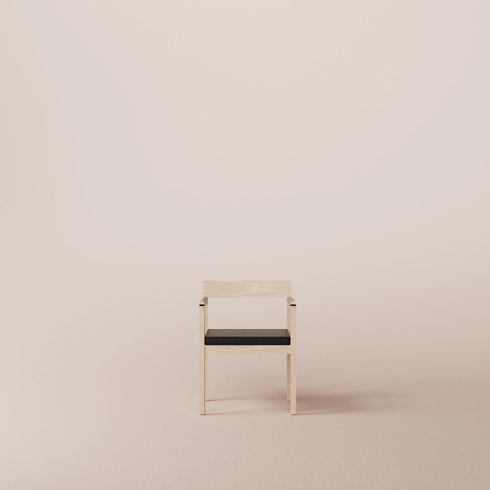 Minimalist chair with black seat on a beige background