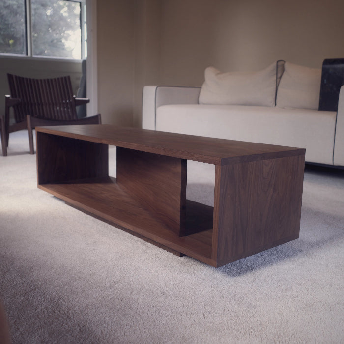 Modern living room with a wooden coffee table and a sofa.