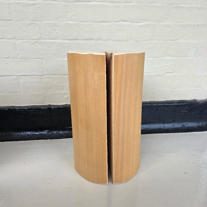 Solid wooden cedar block on a white surface with a white brick wall background