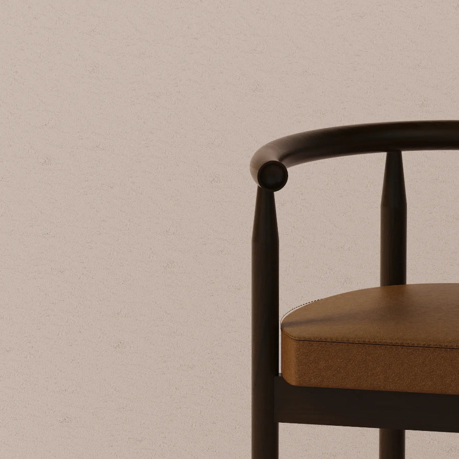 Brown chair with black frame against a beige wall