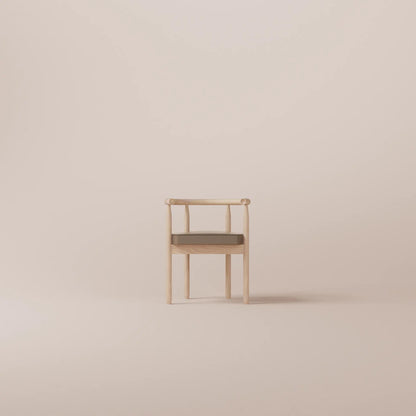 Minimalist chair with a cushion on a beige background