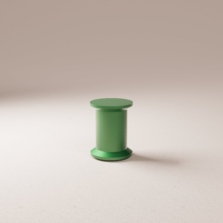 Green spool on a beige background