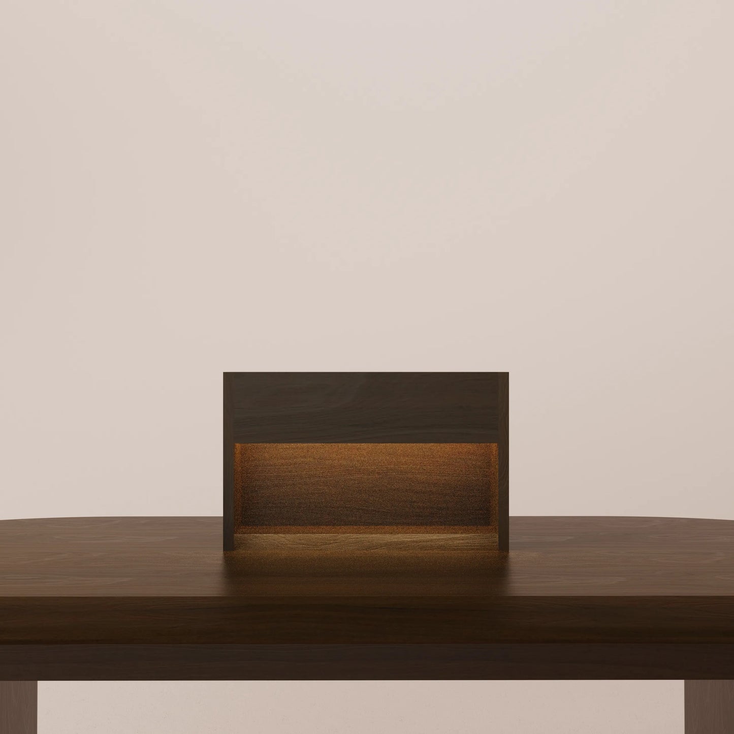 Solid walnut table lamp with a warm glow on a wooden surface against a beige wall