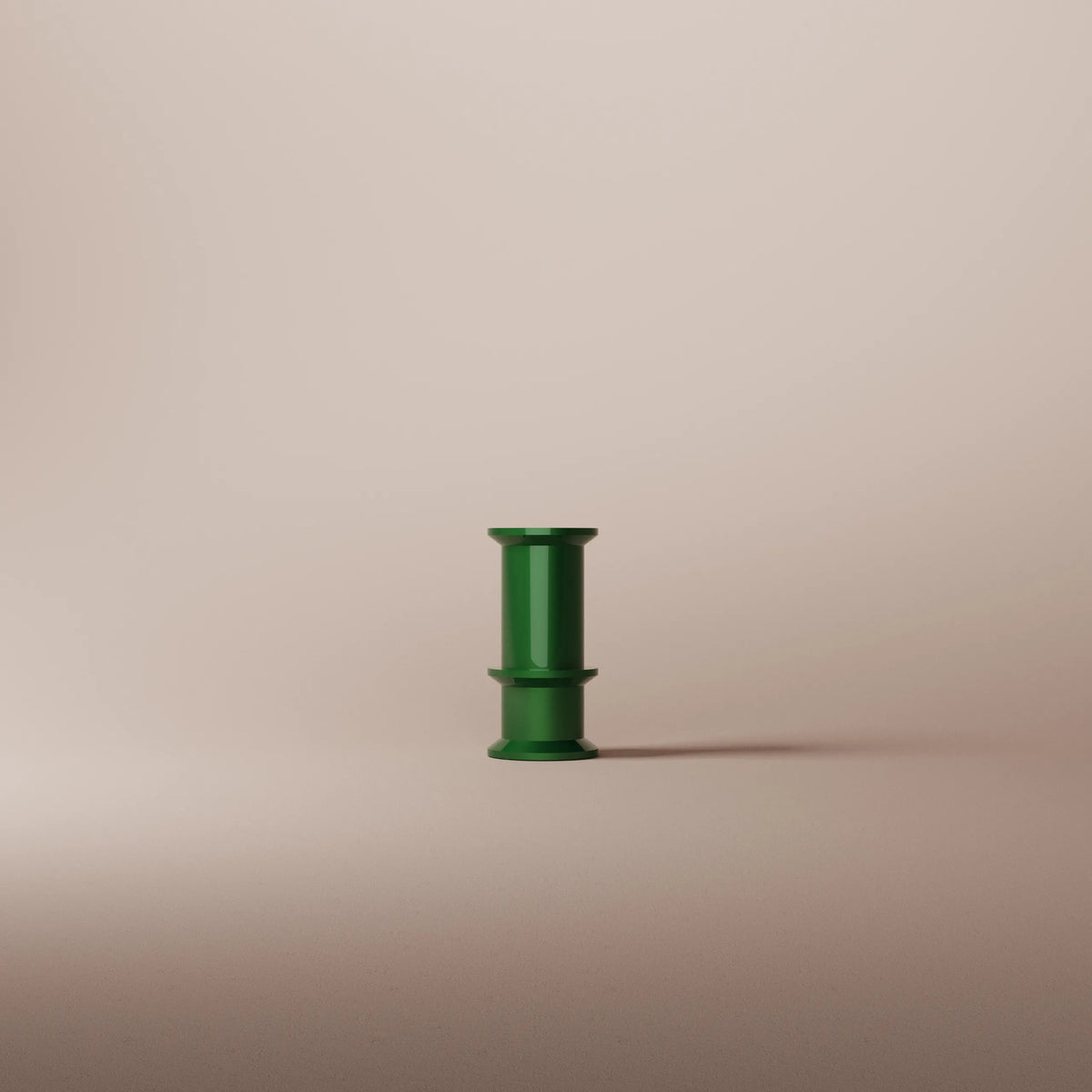 Green cylindrical vase on a beige background