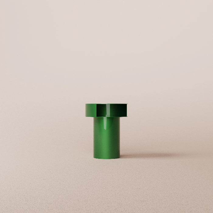 Green cylindrical object on a beige background