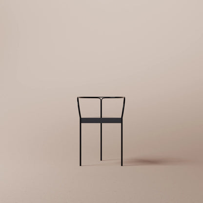 Black chair on a beige background