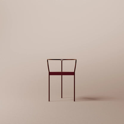 Minimalist chair with a red seat on a beige background