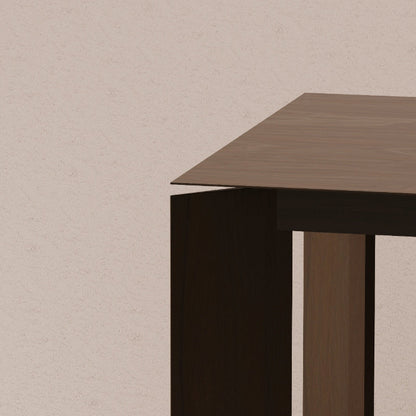 Solid walnut table corner on a beige background