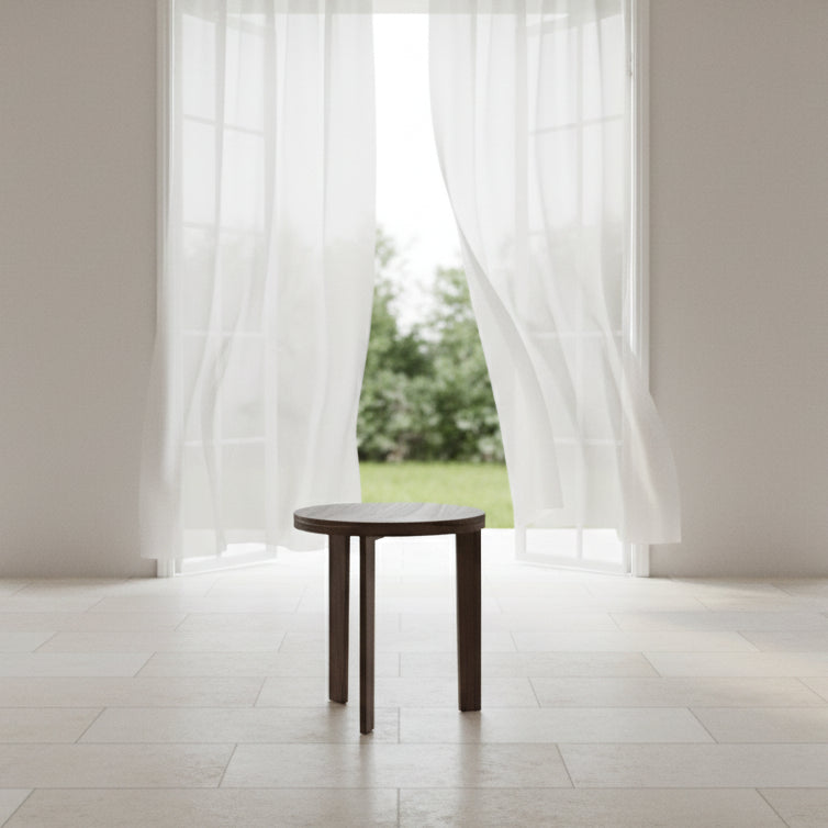 Round wooden side table on a white background
