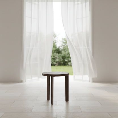 Round wooden side table on a white background